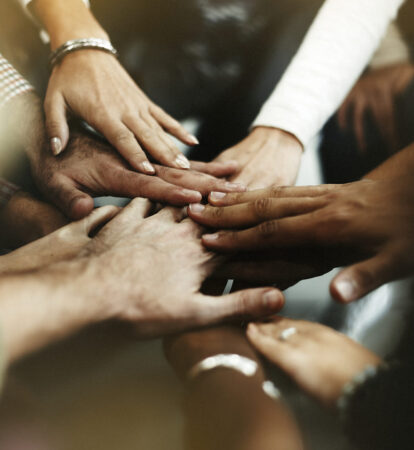 Closeup of diverse people joining their hands