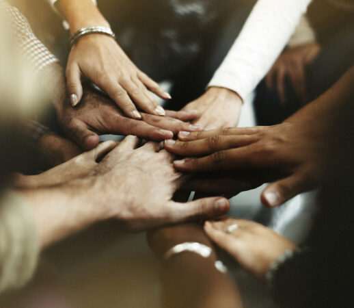 Closeup of diverse people joining their hands